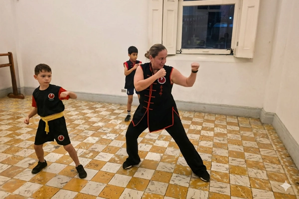 Instructor de Kung Fu enseñando disciplina a un grupo de niños